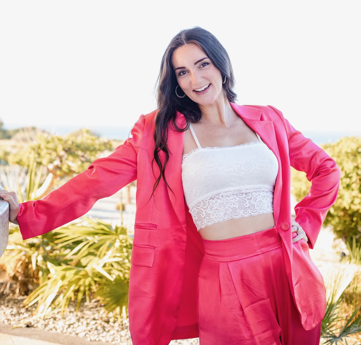Ashley Brasseaux in Cabo, pink suit, smiling